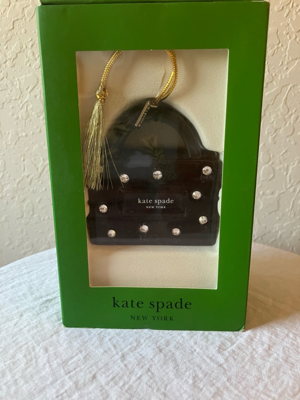 Kate Spade: Black “Be Jolly”Sam Bag Ornament- Gold Tassel